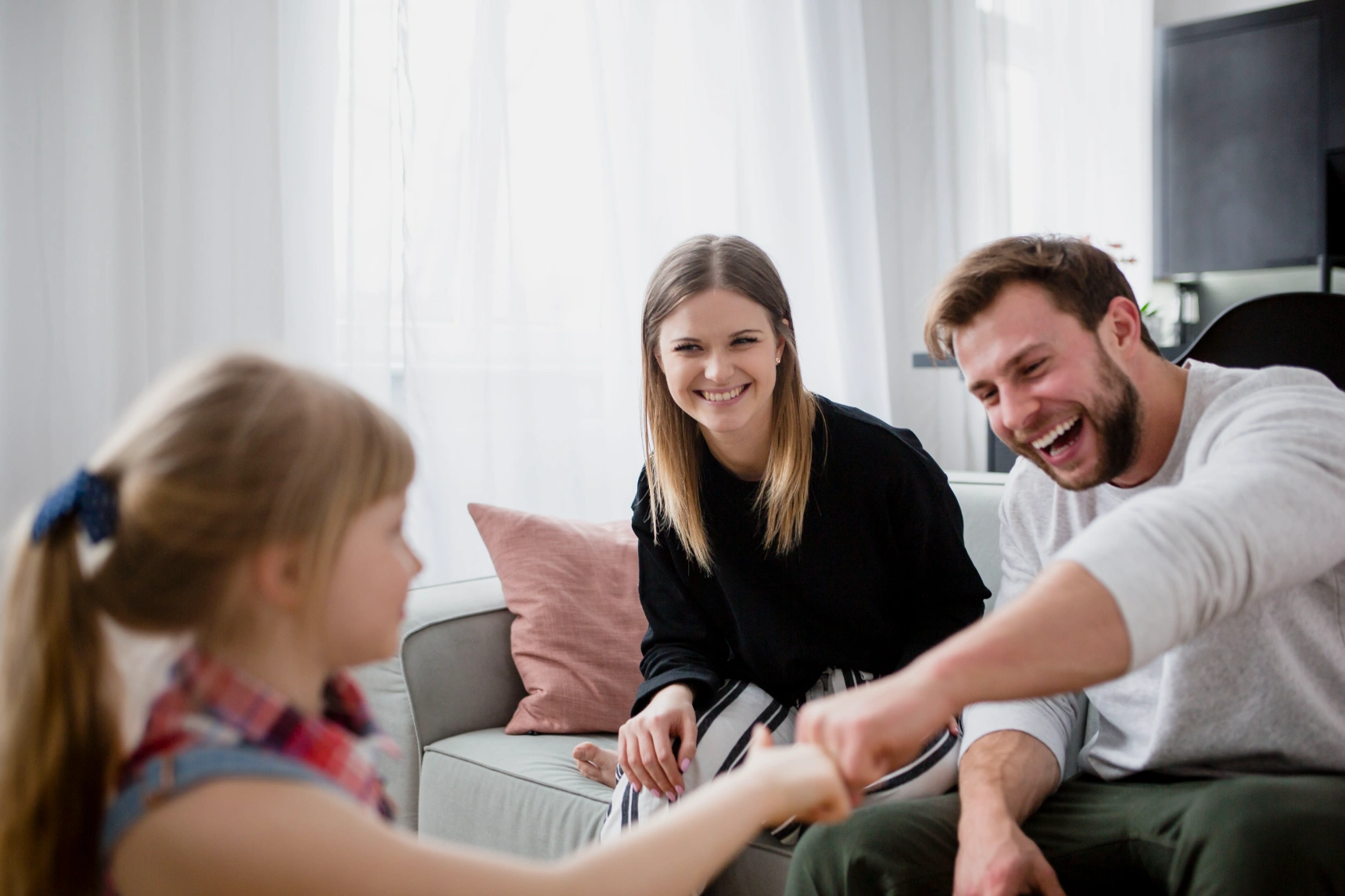 girl-bumping-fists-with-parents