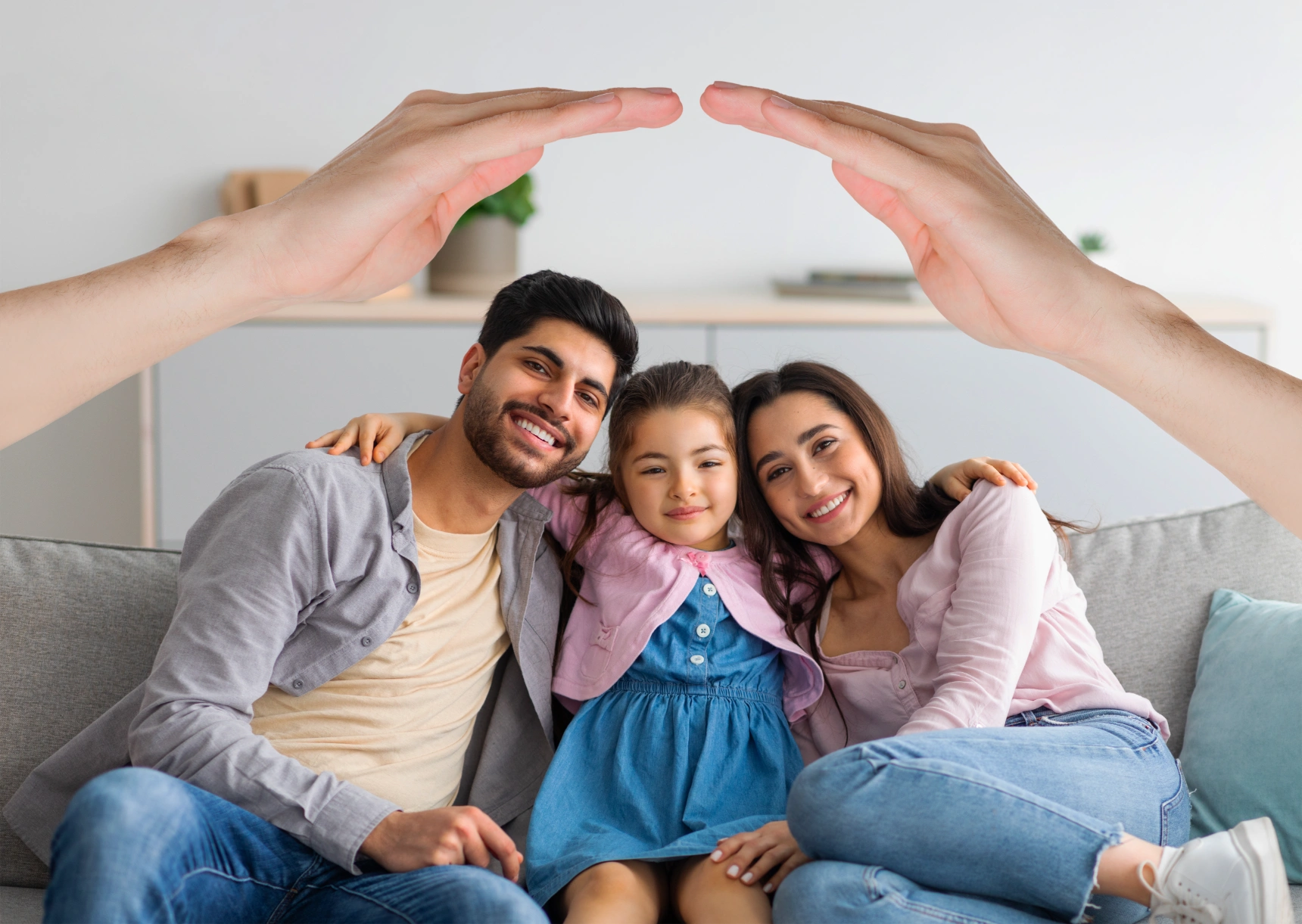happy-interracial-family-posing-home-hands-roof
